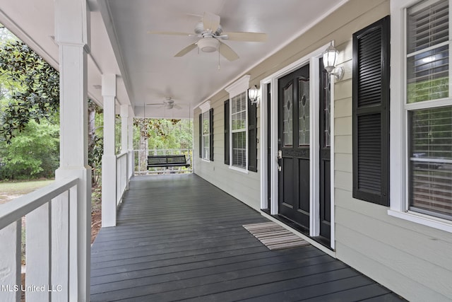 18401 Dogwood Ln, Saucier, MS 39574 - deck featuring a ceiling fan and covered porch