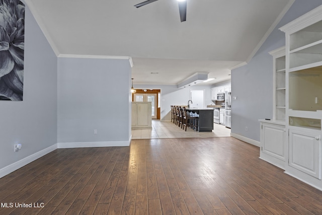 18401 Dogwood Ln, Saucier, MS 39574 - unfurnished living room with dark wood finished floors, ornamental molding, a sink, and a ceiling fan