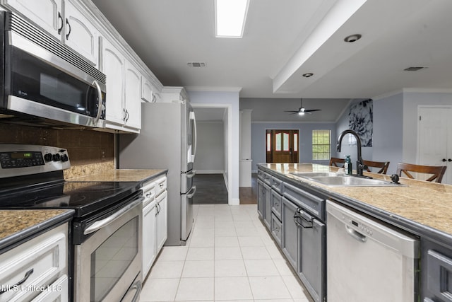 18401 Dogwood Ln, Saucier, MS 39574 - kitchen with stainless steel appliances, white cabinets, a sink, and crown molding
