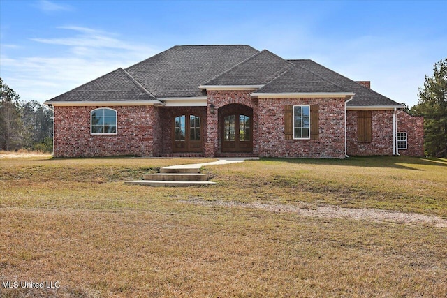 view of front of property with french doors and a front lawn