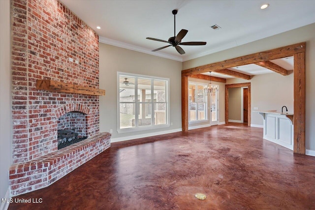 unfurnished living room featuring beam ceiling, ceiling fan with notable chandelier, crown molding, and a fireplace