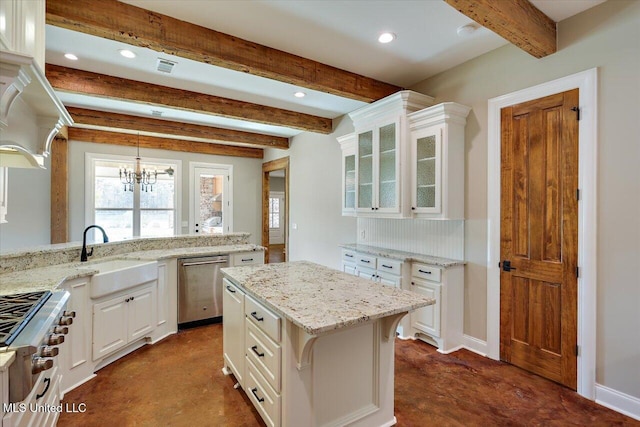 kitchen featuring range, beamed ceiling, a kitchen island, sink, and white cabinetry