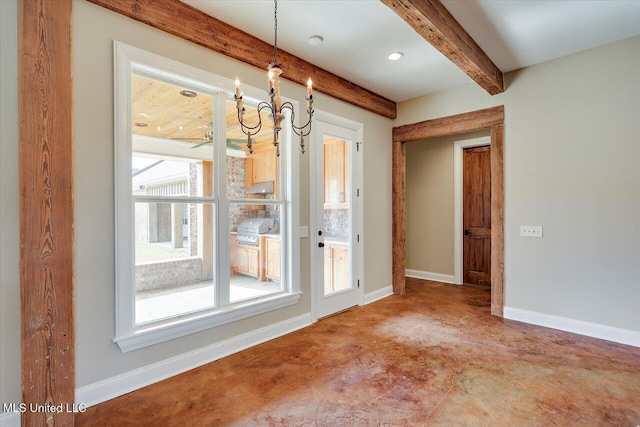 spare room featuring ceiling fan and beam ceiling