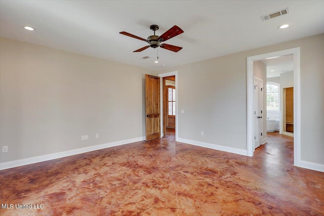 unfurnished room featuring ceiling fan and concrete flooring