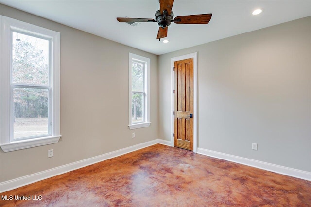 unfurnished room featuring ceiling fan and concrete floors