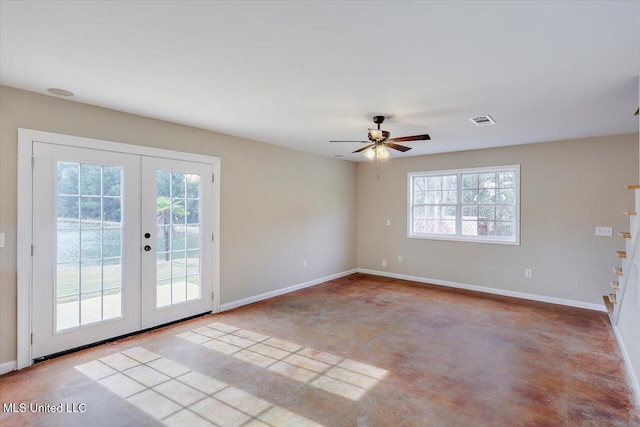 spare room with ceiling fan and french doors