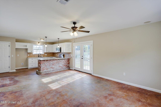 kitchen featuring stainless steel appliances, ceiling fan, french doors, sink, and white cabinetry