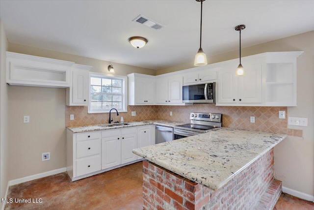 kitchen featuring stainless steel appliances, decorative light fixtures, white cabinetry, and sink