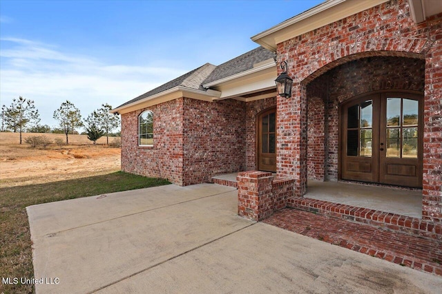 property entrance featuring french doors and a patio area