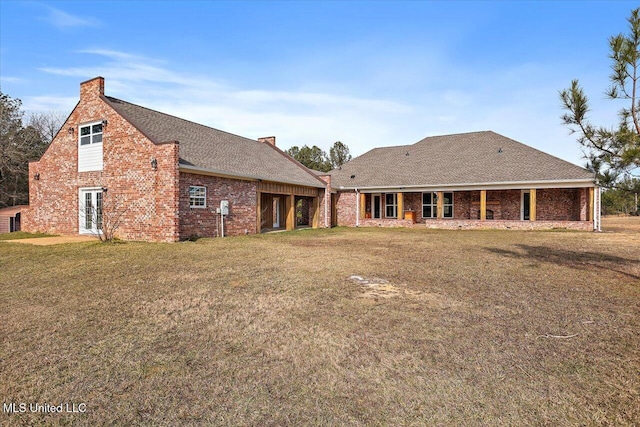 rear view of house with a yard