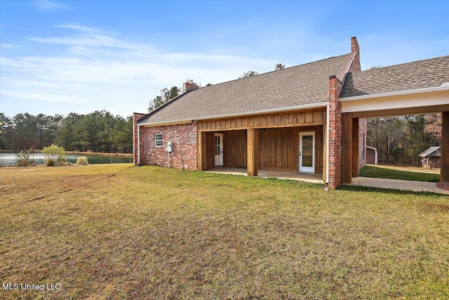 back of house featuring a patio area and a yard