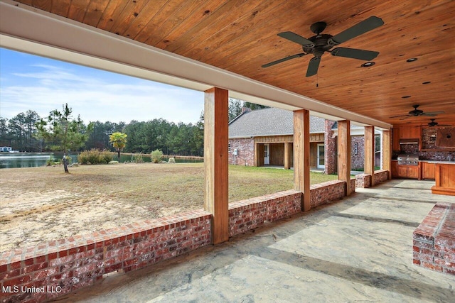 view of patio / terrace with area for grilling, ceiling fan, and a water view