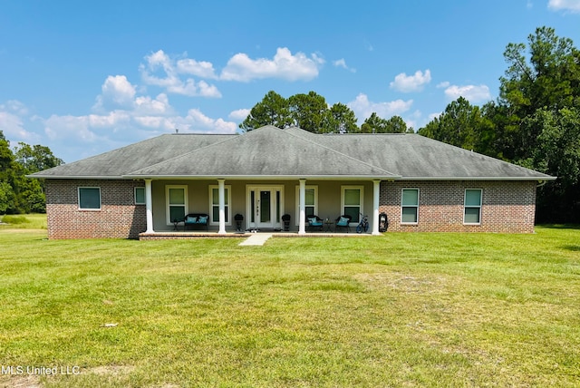 back of house with a yard and a patio area