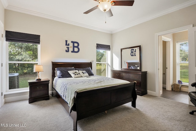 carpeted bedroom with ceiling fan and crown molding