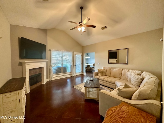 tiled living room with ceiling fan, a fireplace, and vaulted ceiling