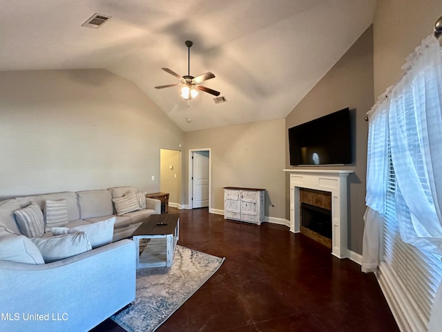 living room with ceiling fan, a tile fireplace, and vaulted ceiling