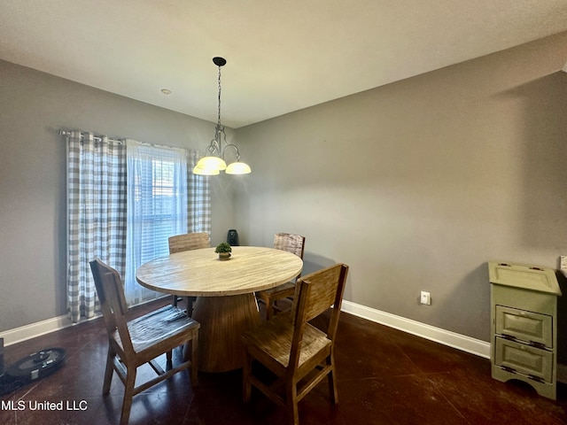 tiled dining room featuring an inviting chandelier