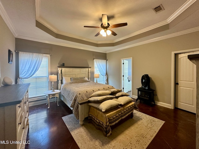 bedroom with a raised ceiling, crown molding, and ceiling fan