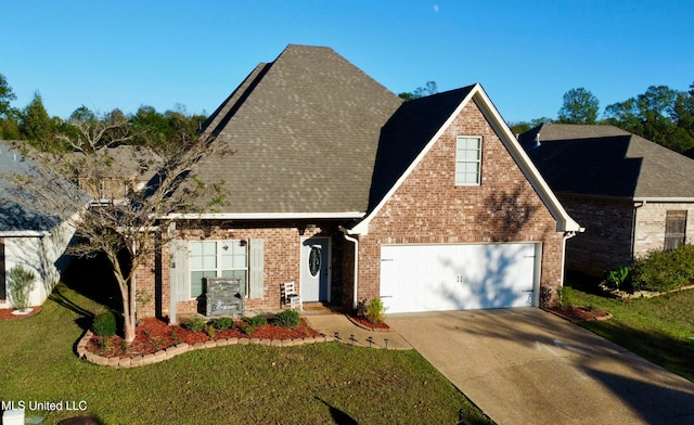 view of front of home featuring a garage and a front lawn