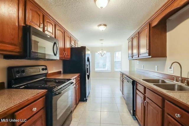 kitchen with sink, a notable chandelier, pendant lighting, light tile patterned flooring, and black appliances