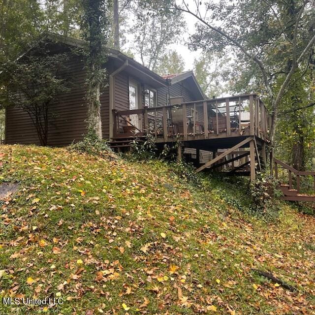 back of property with a wooden deck