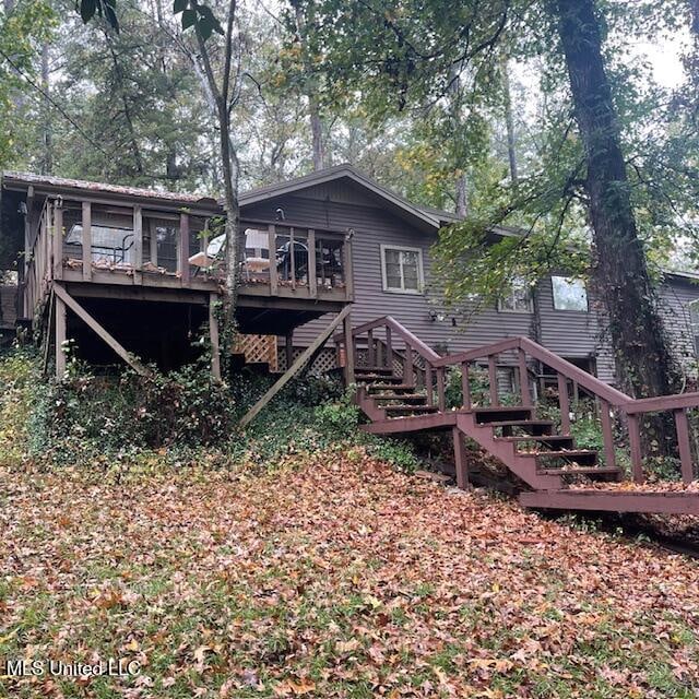 back of property with a wooden deck