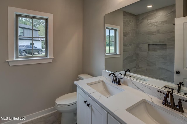 9070 Bennett Trl, Hernando, MS 38632 - bathroom with toilet, baseboards, plenty of natural light, and double vanity