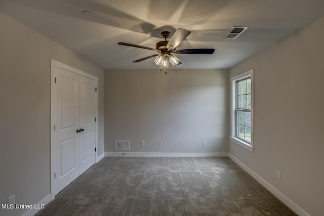 carpeted spare room with ceiling fan