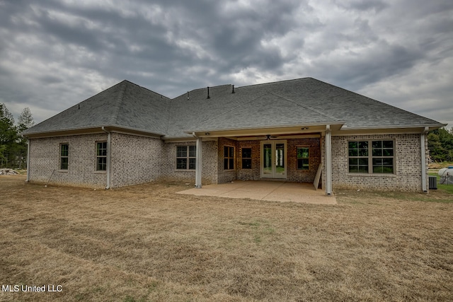 rear view of house with a yard and a patio area