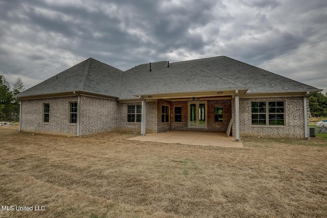 9070 Bennett Trl, Hernando, MS 38632 - rear view of property featuring brick siding, a shingled roof, a patio, and a lawn