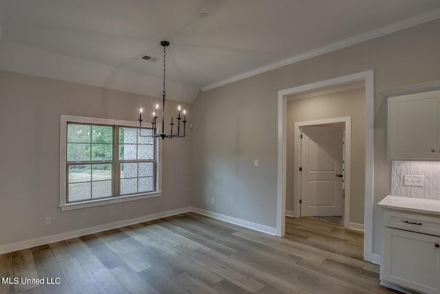 9070 Bennett Trl, Hernando, MS 38632 - unfurnished dining area with a chandelier, ornamental molding, light wood finished floors, and baseboards