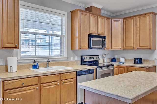 kitchen featuring sink, tile counters, stainless steel appliances, and ornamental molding