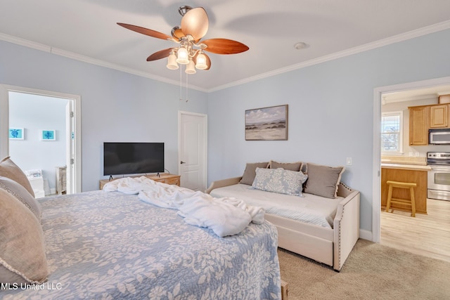 bedroom with crown molding, ceiling fan, ensuite bathroom, and light carpet