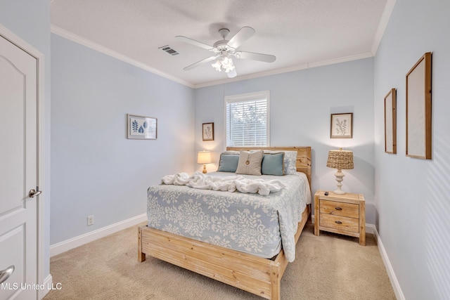 carpeted bedroom featuring ornamental molding, a textured ceiling, and ceiling fan