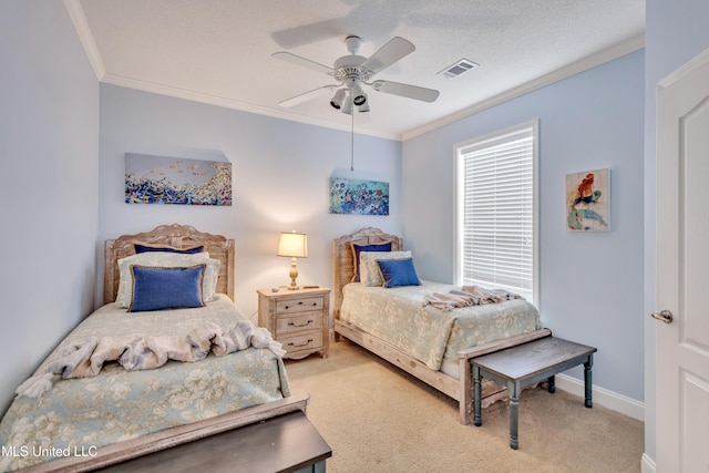 bedroom with ornamental molding, carpet, a textured ceiling, and ceiling fan