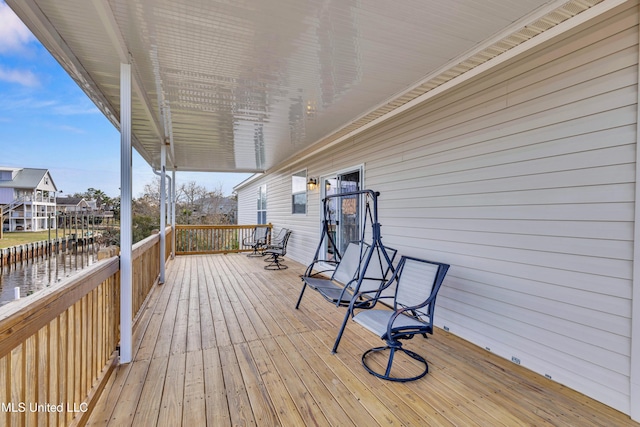 wooden terrace featuring a water view