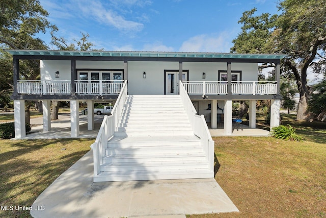 rear view of house featuring a patio and a yard