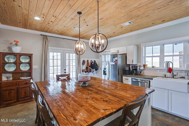 148 Stanton Hall Dr, Florence, MS 39073 - kitchen with stainless steel appliances, wooden ceiling, ornamental molding, a chandelier, and wooden counters