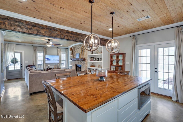 148 Stanton Hall Dr, Florence, MS 39073 - kitchen with finished concrete flooring, wooden ceiling, a chandelier, white cabinets, and crown molding