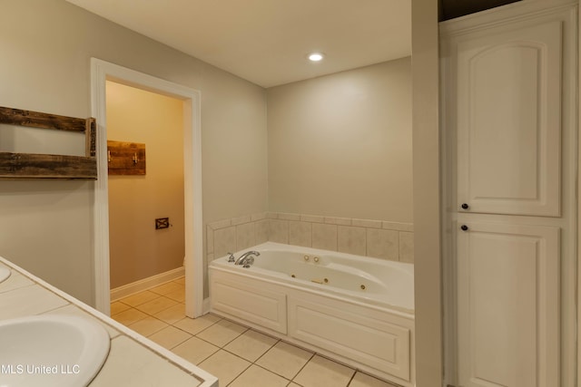 bathroom with recessed lighting, a jetted tub, baseboards, and tile patterned floors