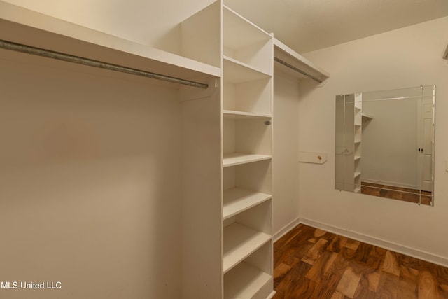 walk in closet featuring dark wood-type flooring