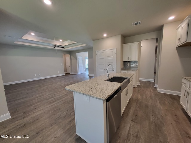 kitchen featuring dark wood-style floors, a raised ceiling, visible vents, a sink, and dishwasher