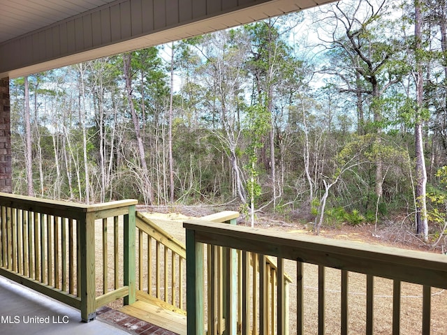 wooden deck with a wooded view