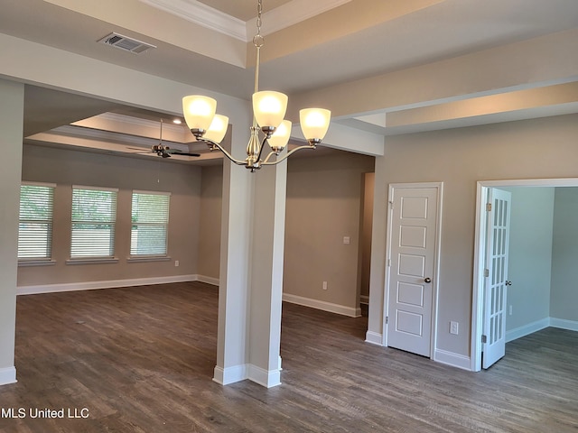 unfurnished dining area with a raised ceiling, visible vents, ornamental molding, dark wood-type flooring, and baseboards