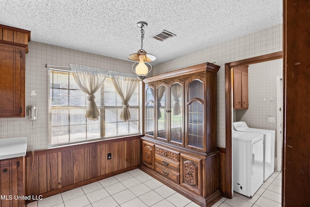 465 Heritage Pl, Jackson, MS 39212 - unfurnished dining area with independent washer and dryer, light tile patterned floors, and a textured ceiling