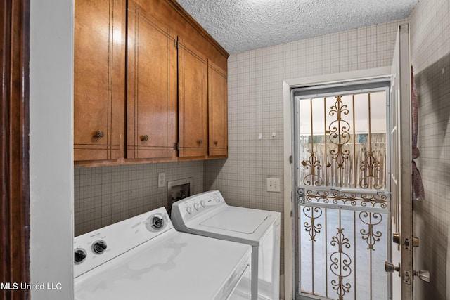 465 Heritage Pl, Jackson, MS 39212 - clothes washing area with cabinet space, independent washer and dryer, and a textured ceiling