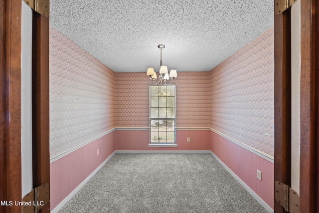 465 Heritage Pl, Jackson, MS 39212 - spare room with a chandelier, a textured ceiling, carpet, and wallpapered walls