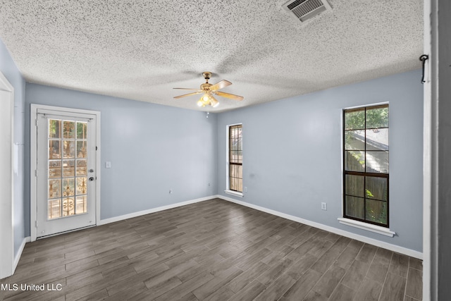 465 Heritage Pl, Jackson, MS 39212 - unfurnished room featuring ceiling fan, dark wood finished floors, baseboards, and a textured ceiling