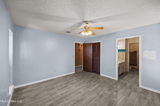 465 Heritage Pl, Jackson, MS 39212 - unfurnished bedroom featuring wood finished floors, a closet, baseboards, a textured ceiling, and a ceiling fan
