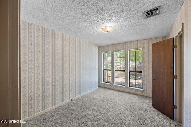 465 Heritage Pl, Jackson, MS 39212 - empty room with wallpapered walls, a textured ceiling, and carpet floors